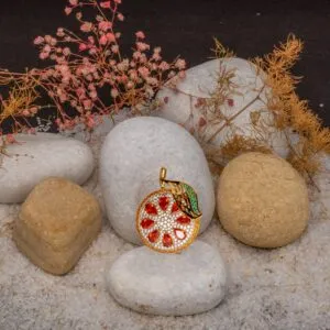 JBRH1034 — THE CITRUS EMPRESS: Radiant orange teardrop stones, white-stone sparkle and sculptural leaves create a vivid citrus-inspired brooch with a gold-toned outline.